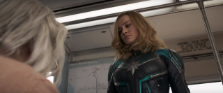 Wprawiająca niektórych widzów w osłupienie scena z uderzeniem starszej kobiety; przypomnijmy, że Skrulle potrafią zmieniać swój kształt - bohaterka trafia najprawdopodobniej na jedną z nich; wszystko wskazuje na to, że po uderzeniu następuje sekwencja walki i pościgu - to w jej trakcie Carol ujawnia swoje moce po raz pierwszy od powrotu na Ziemię